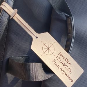 Wooden luggage tag on a backpack.