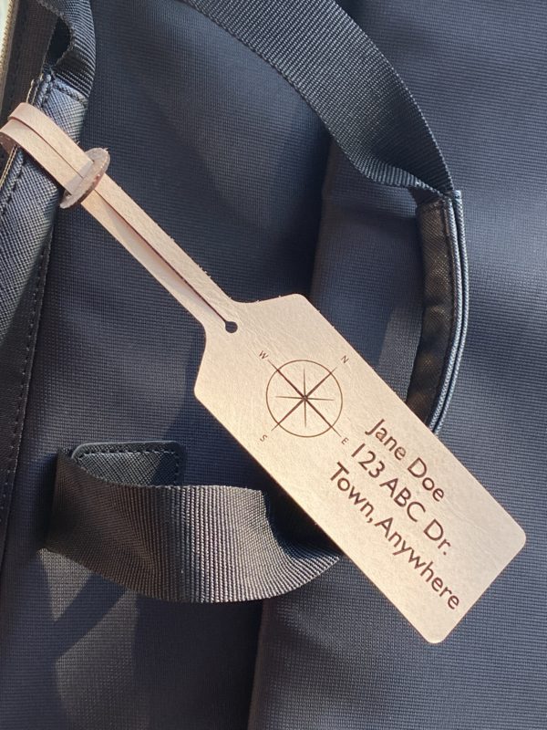 Wooden luggage tag on a backpack.